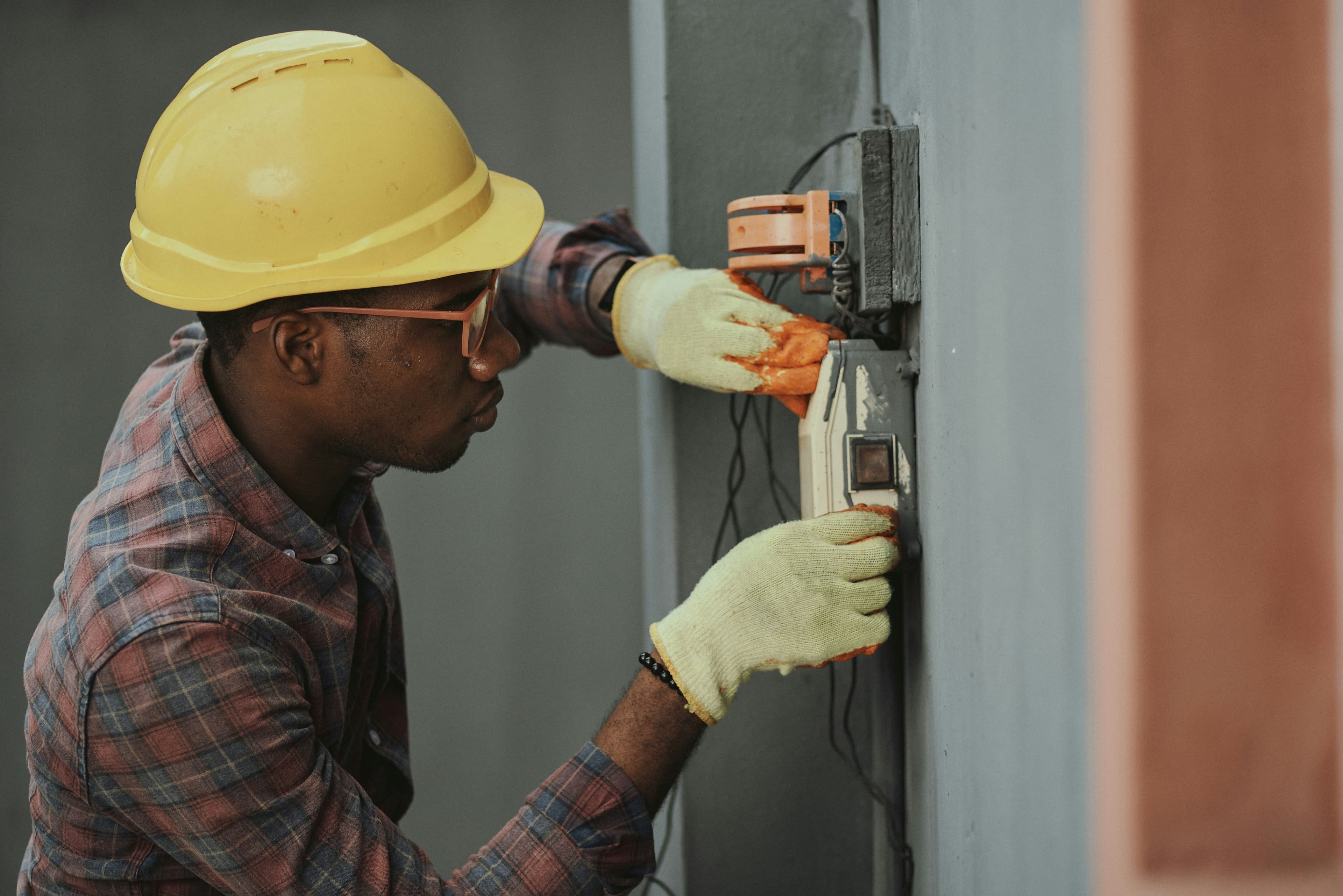Electrician working on electrical panel